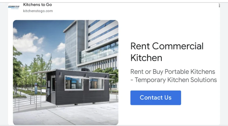Bannière display Kitchens To Go : Rent Commercial Kitchen, photographie d'un module cuisine noir installé devant un immeuble de bureaux vitré.